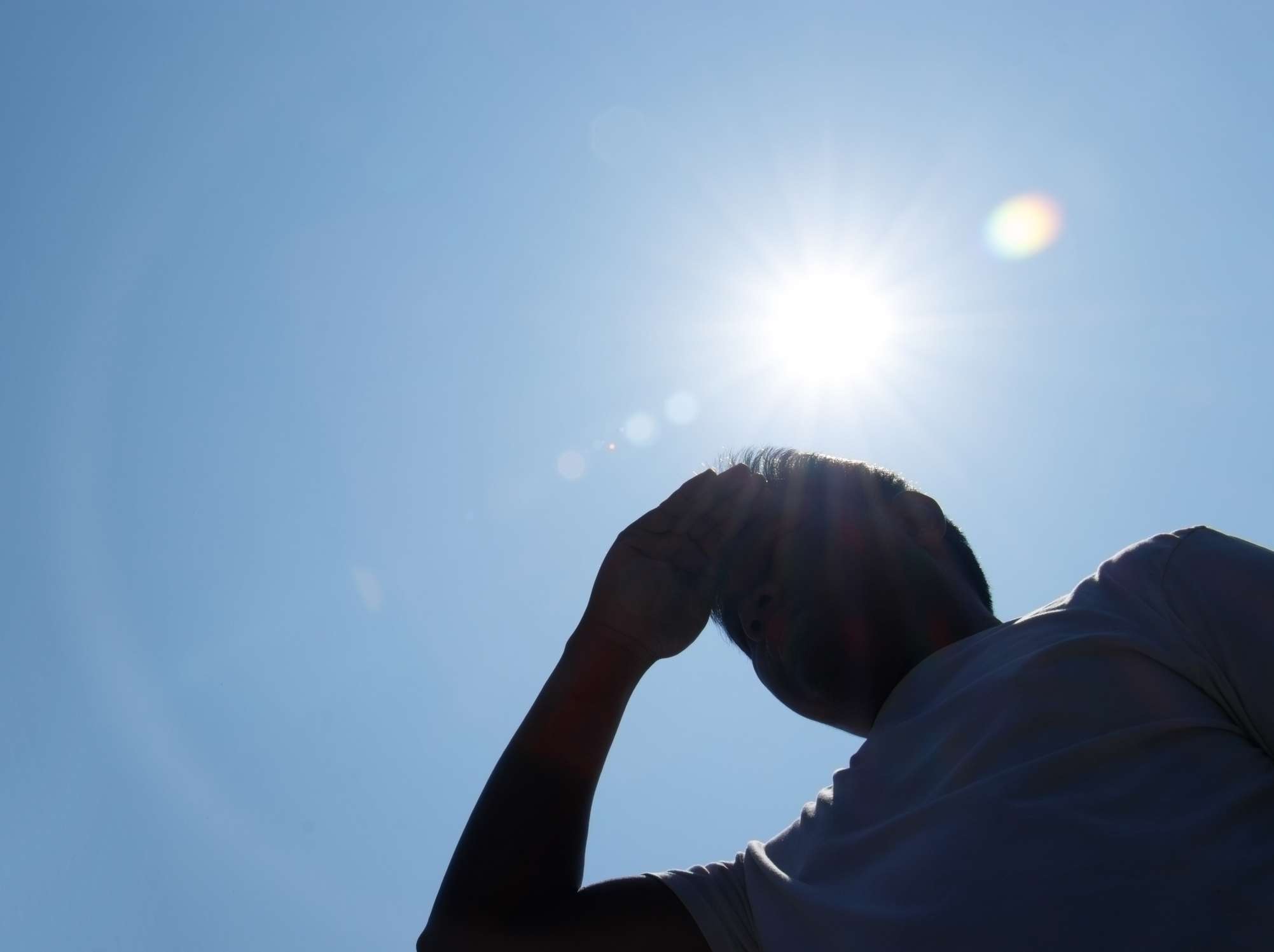 person with hot sun in background