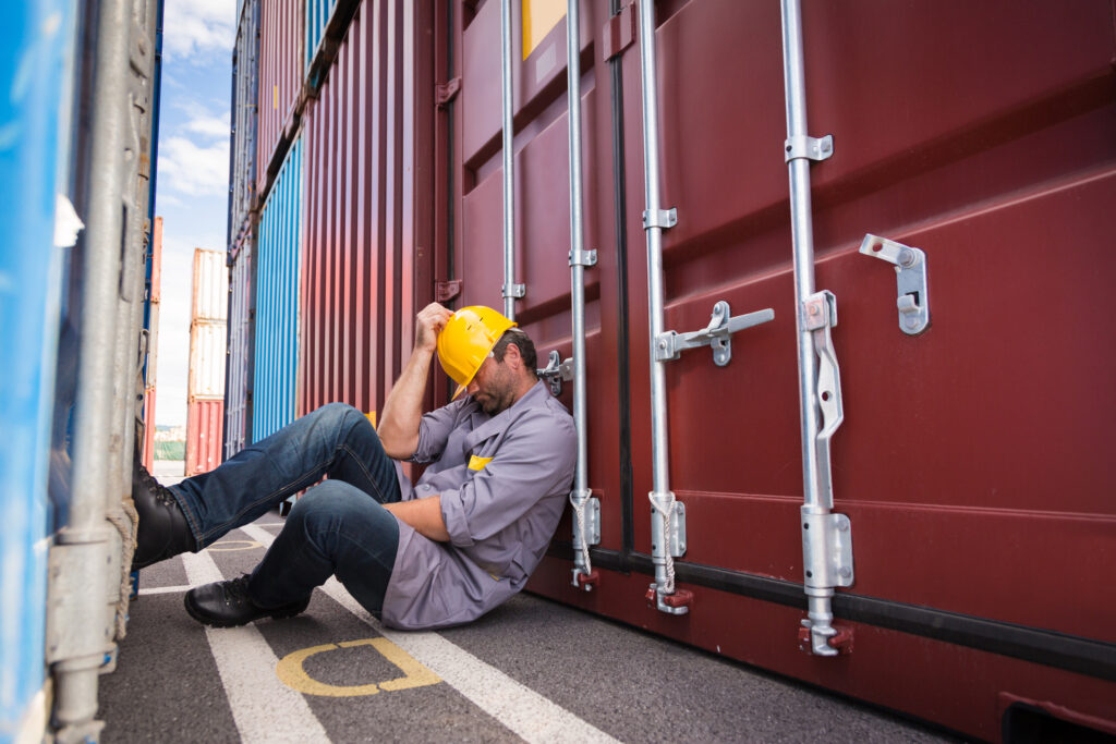 worker napping in container port