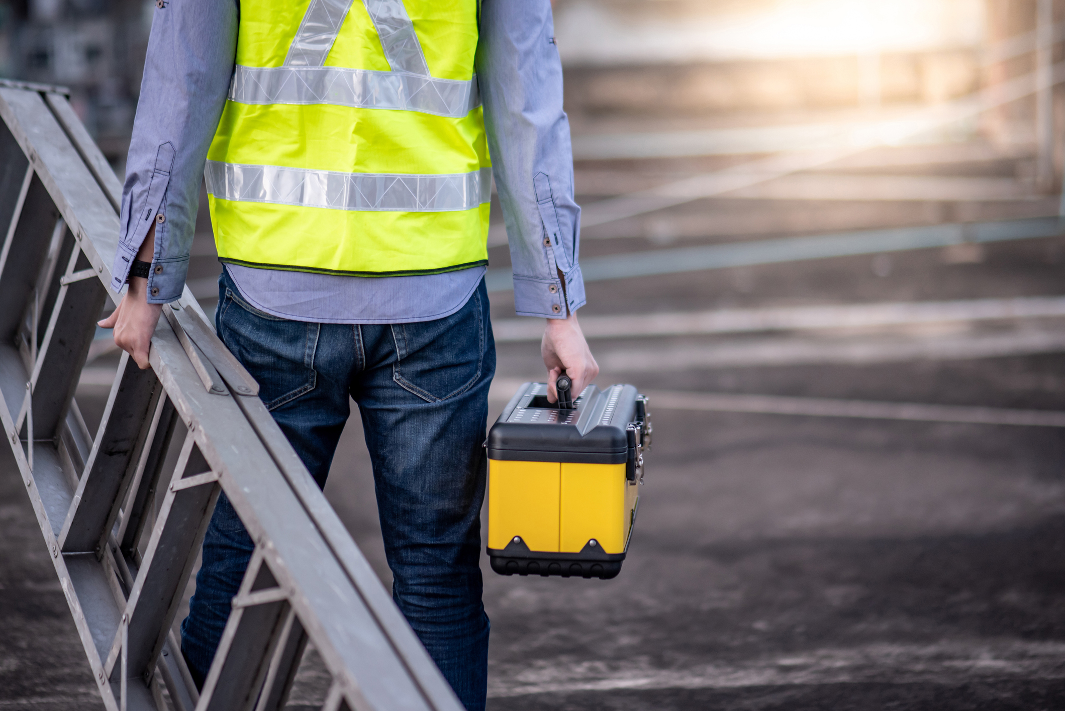 maintenance worker with ladder and tool box