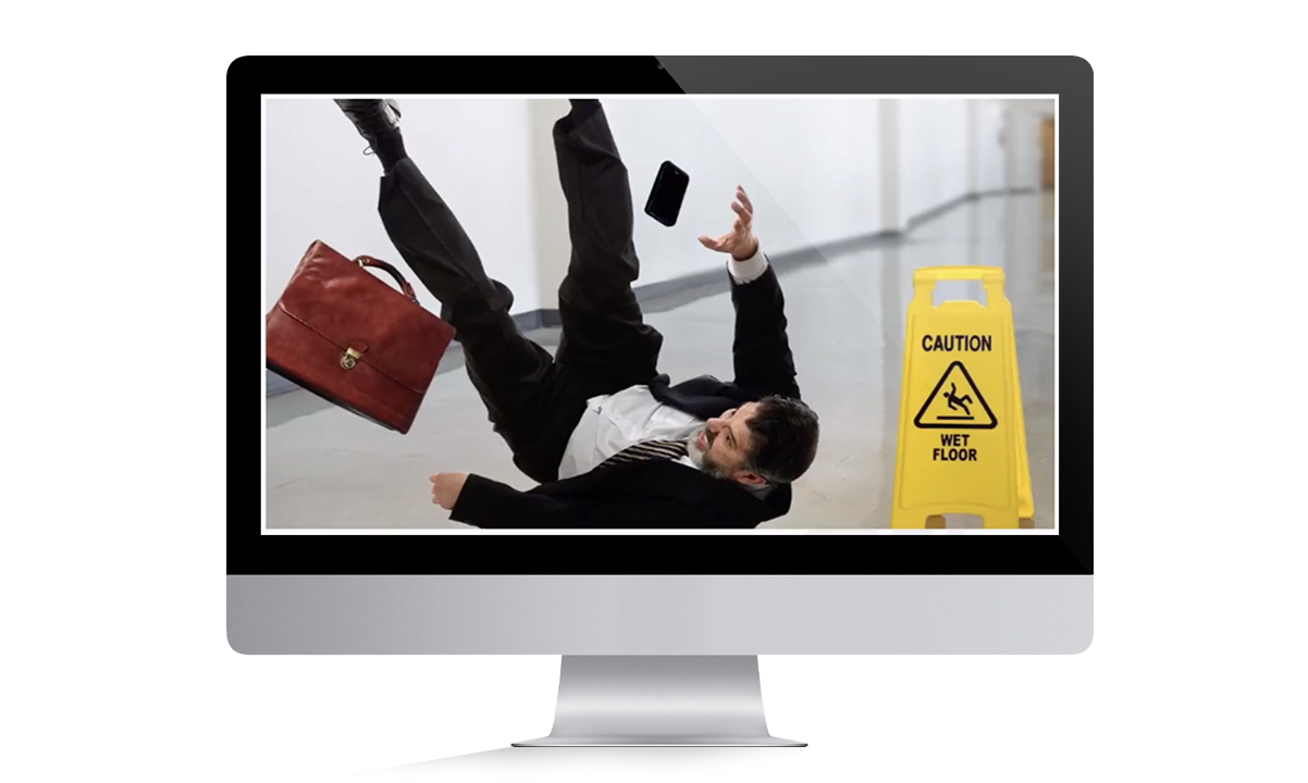 man slips, falls with his belongings scattering amok next to caution wet floor sign